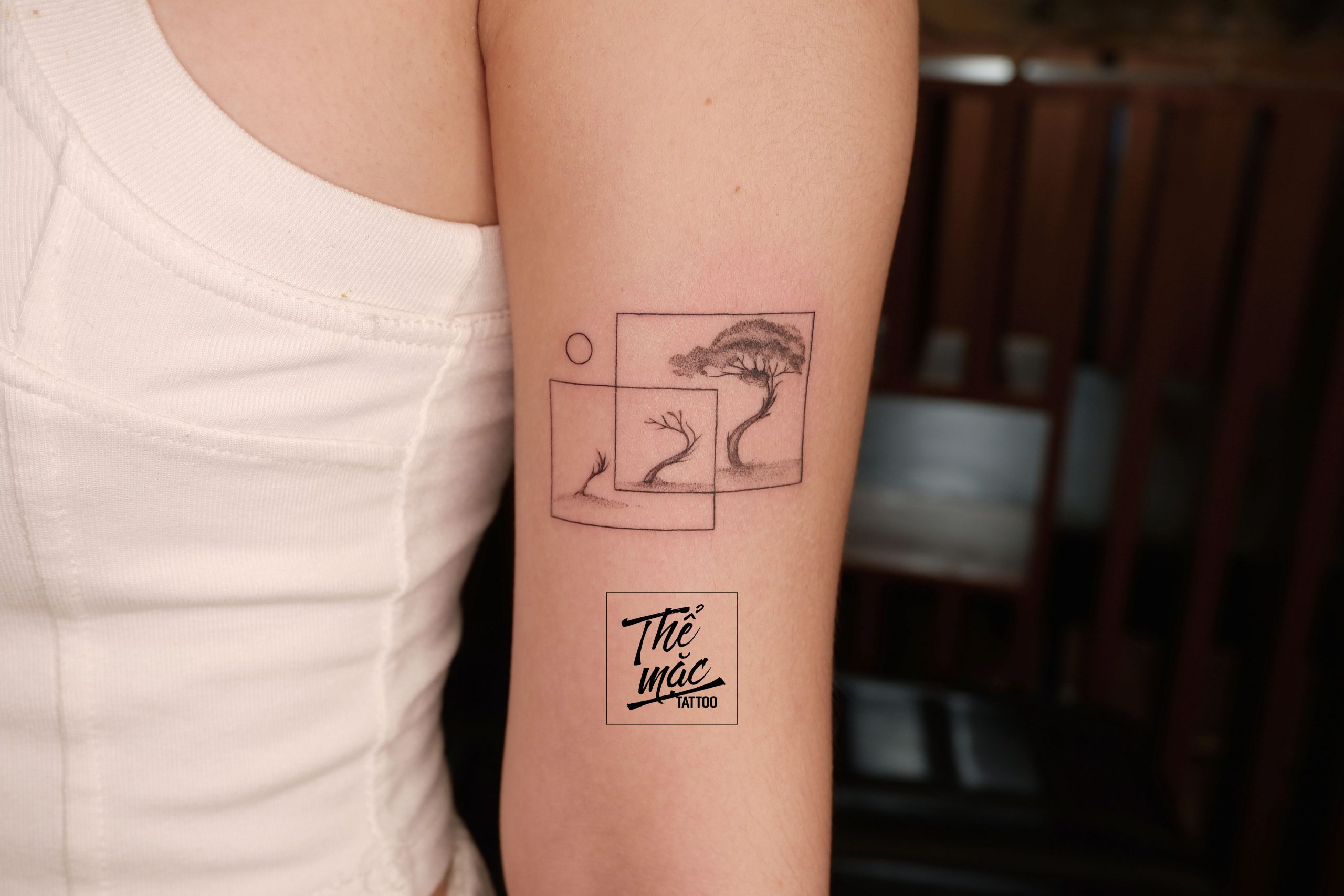 Minimalist bonsai fine line tattoo with layered frames – subtle and elegant body art by Thể Mặc Tattoo in Saigon.