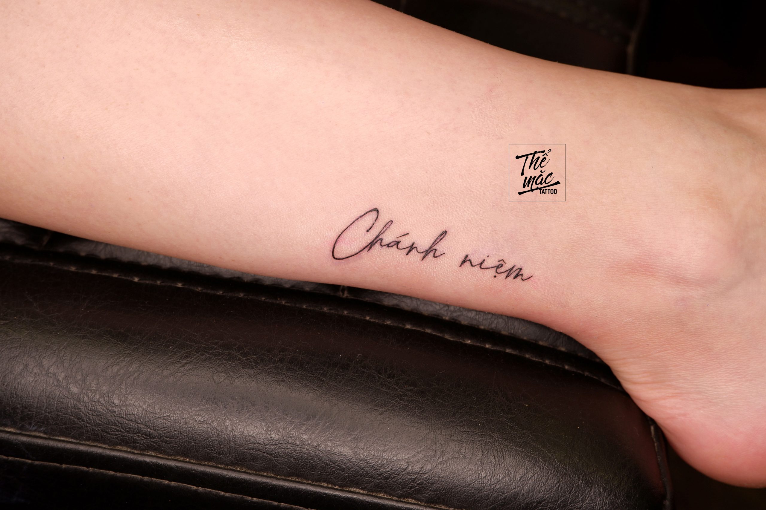 Vietnamese script tattoo “Chánh niệm” (Mindfulness) in fine line calligraphy – peaceful and personal tattoo made at Thể Mặc Studio.